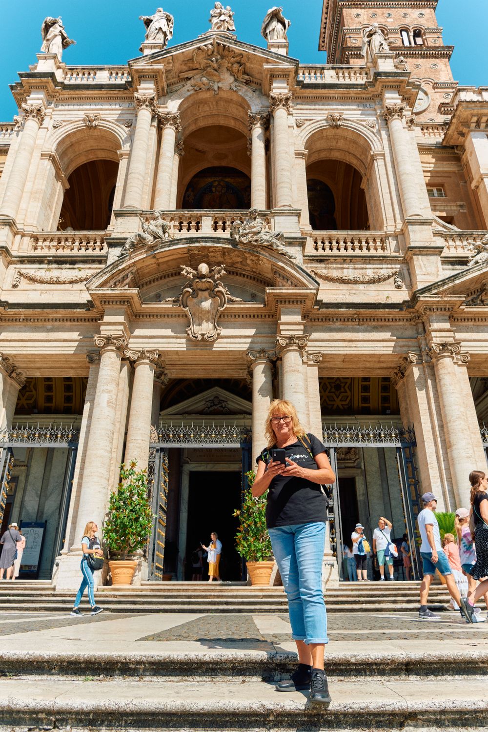Ornate Baroque church facade with grand columns and statues decorating the entrance steps.