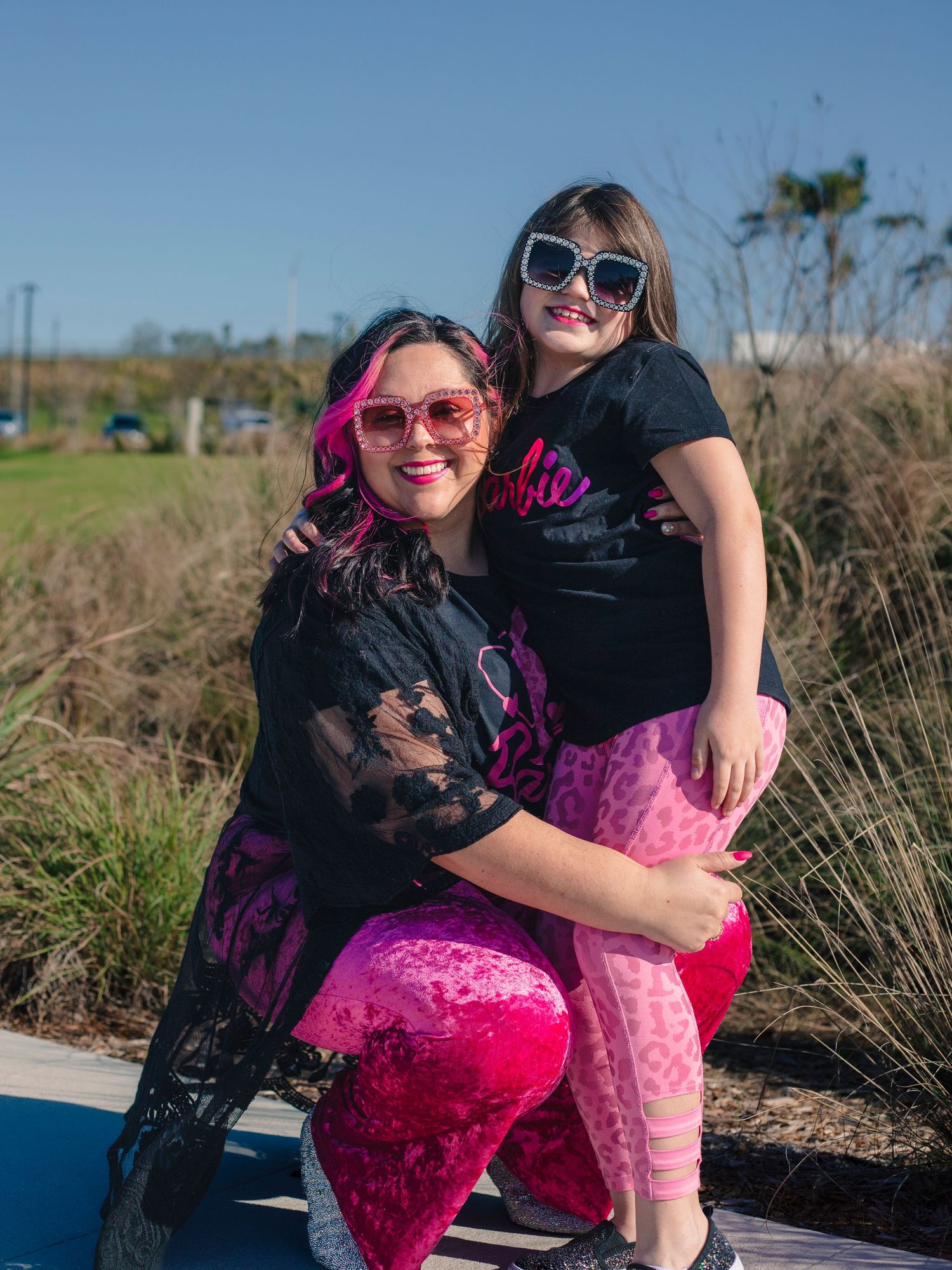 Stepmom and daughter dressed in pink for a photo