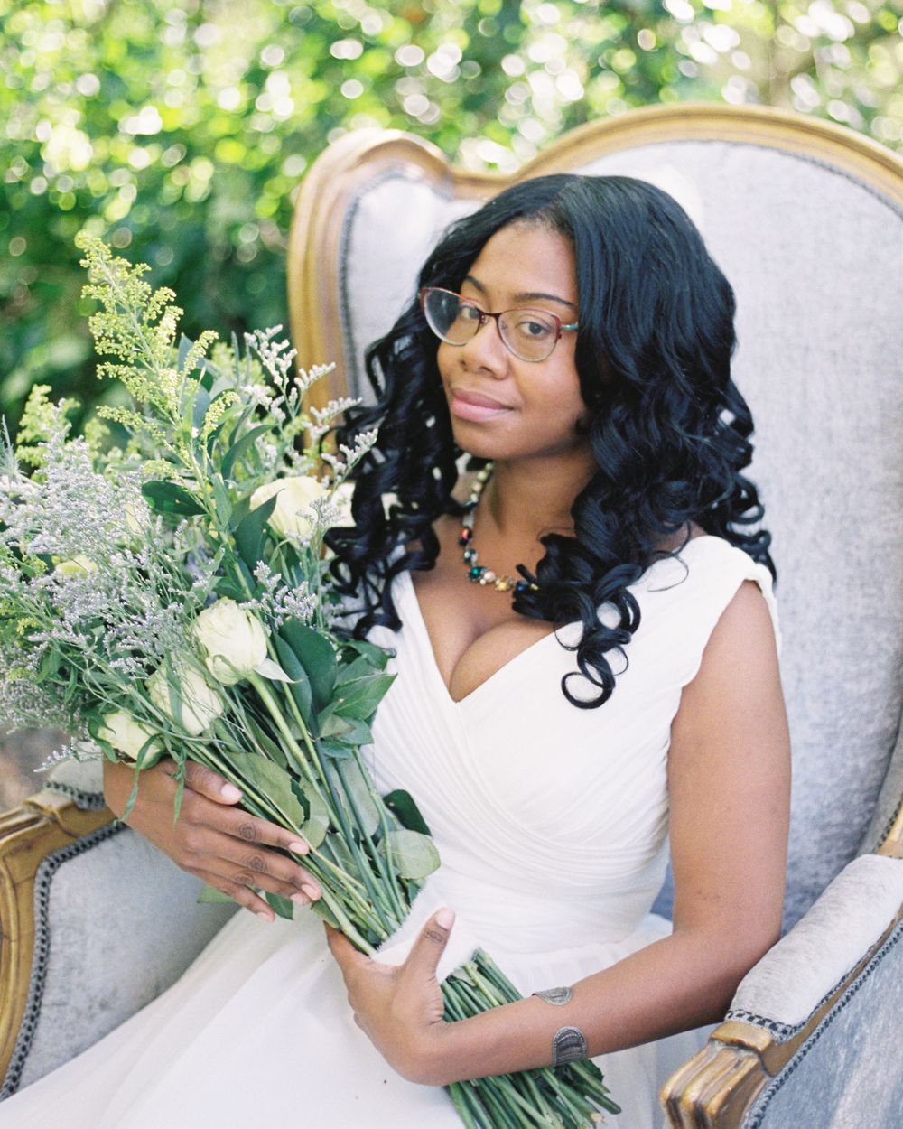 Bride sitting in throne holding flowers Bold Monk Brewery Atlanta, GA