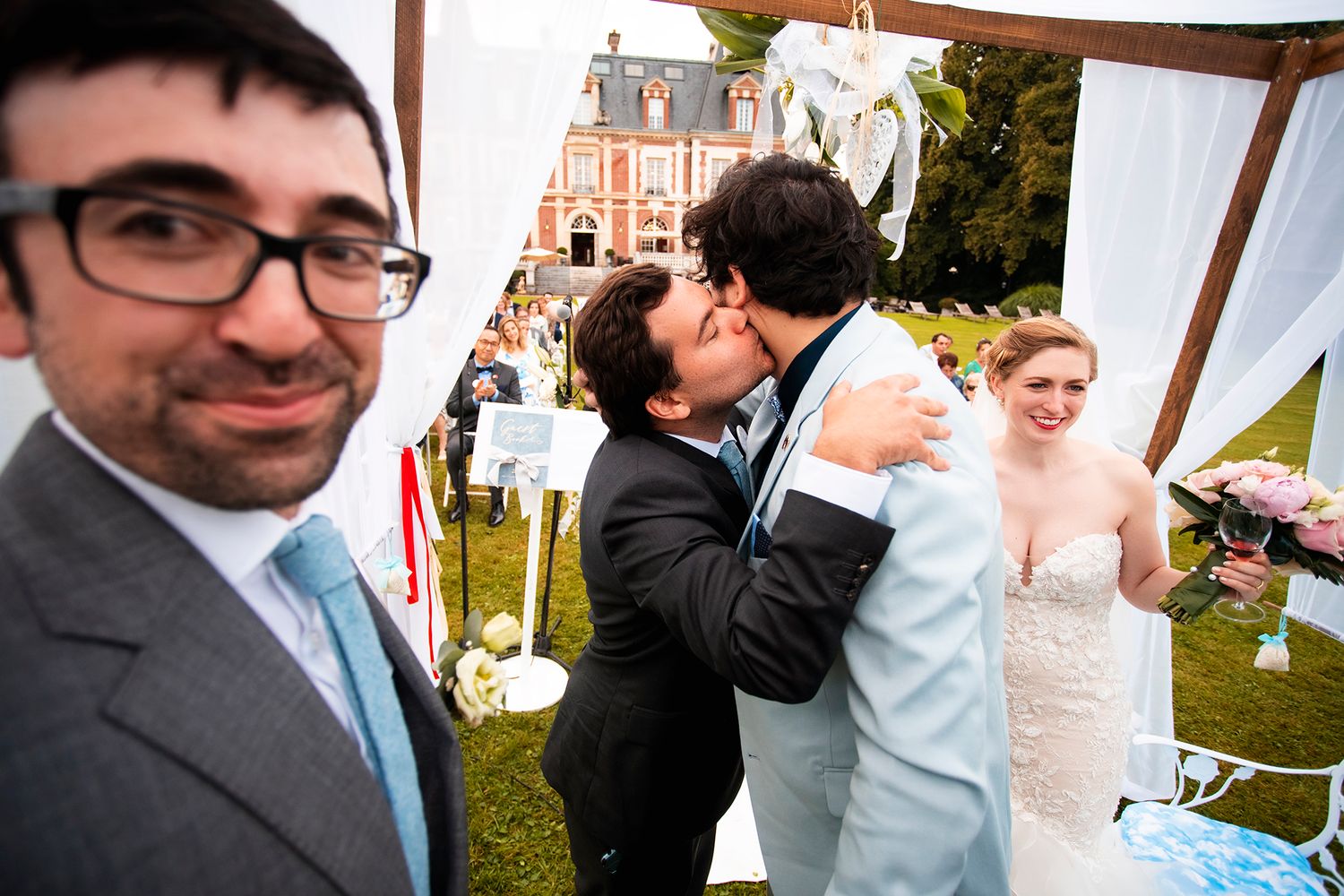 Fun candid wedding moment captured during outdoor ceremony with guests and decor.