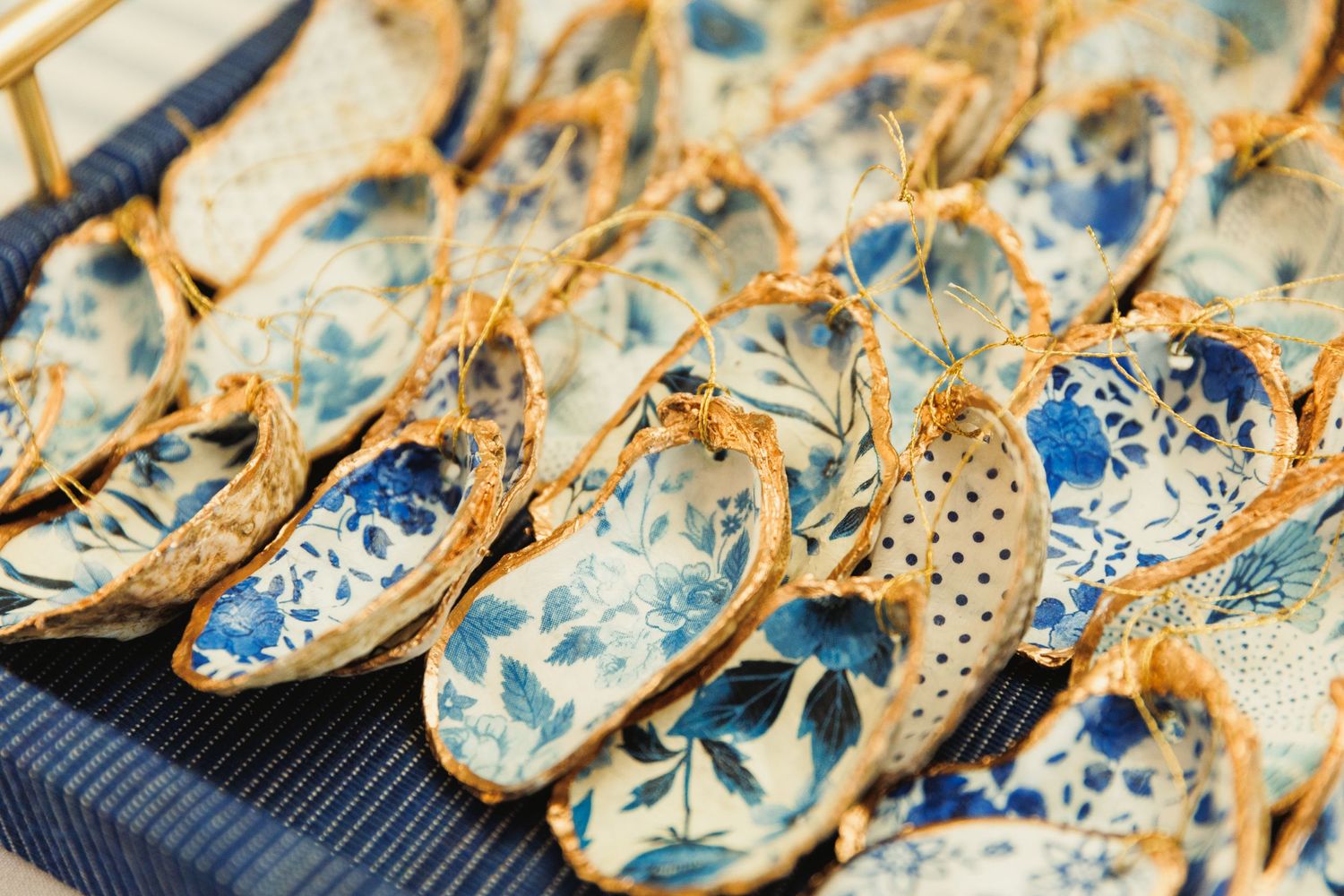 Delicate blue and white porcelain cookies arranged in a decorative pattern on a rustic surface.