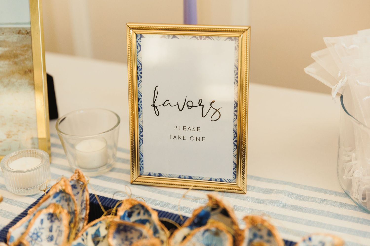 Elegant gold-framed place cards and table settings at wedding reception.