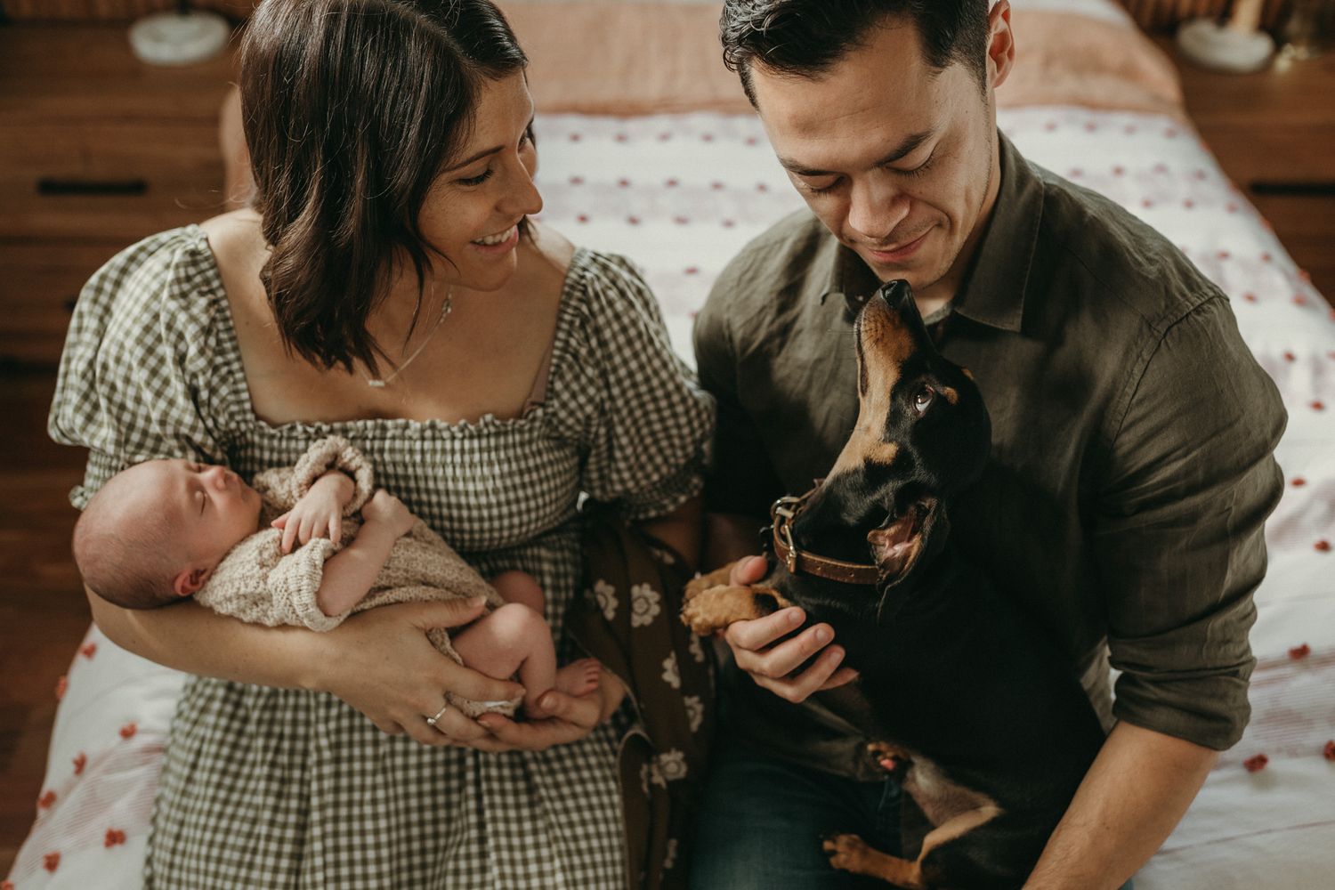 Family photoshoot at home with their newborn and dog