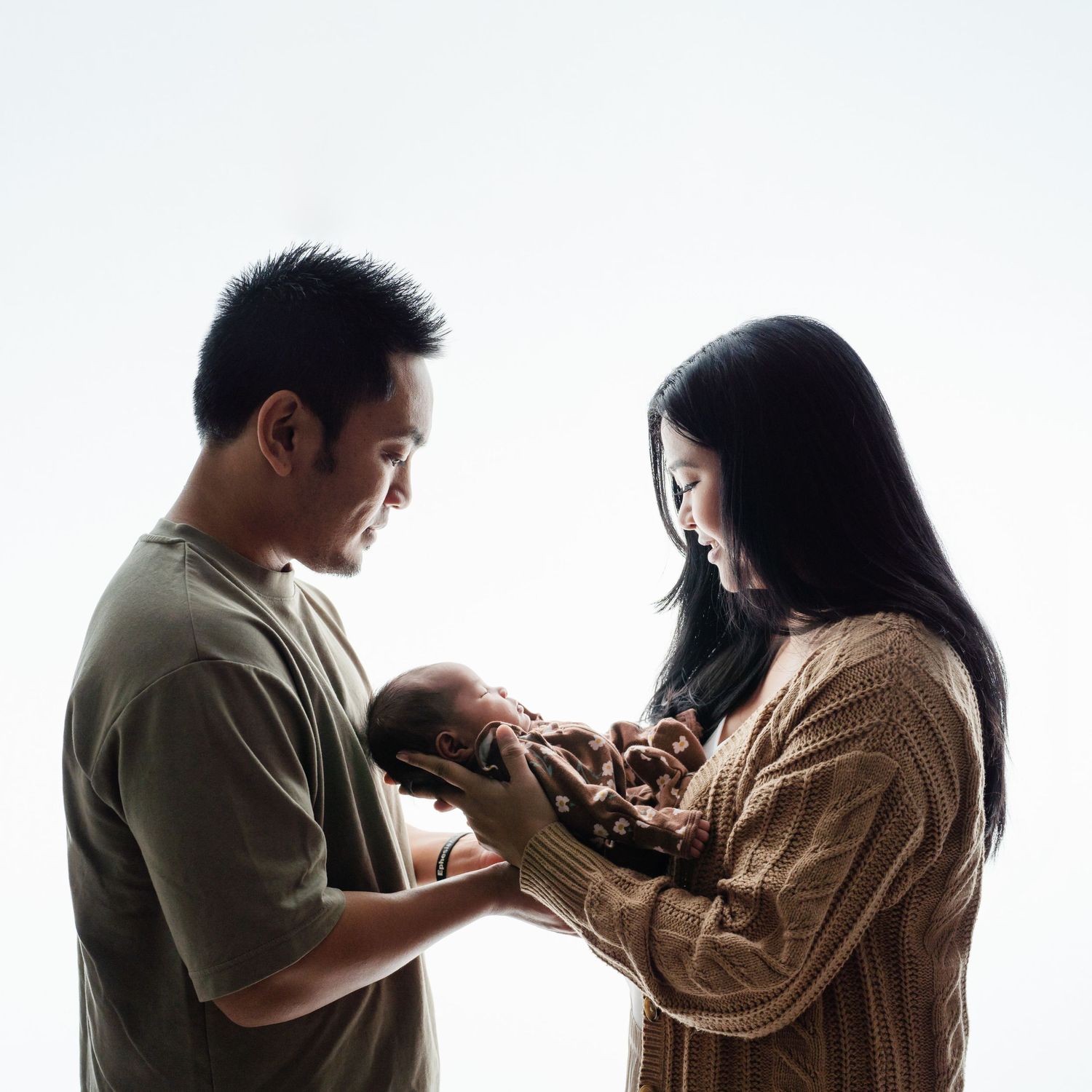 parents holding newborn baby
