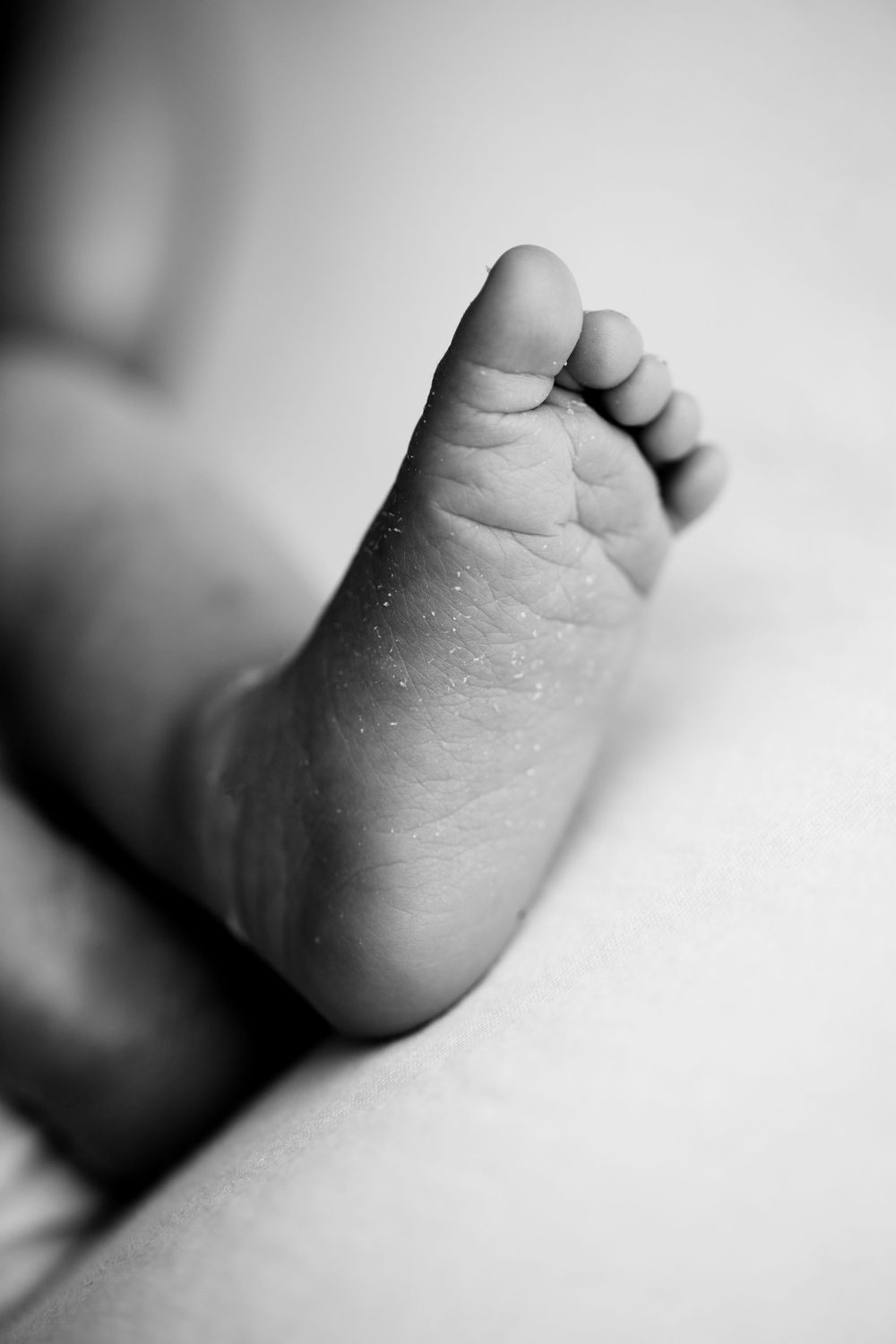 Newborn baby boy black and white image of closeup foot image.