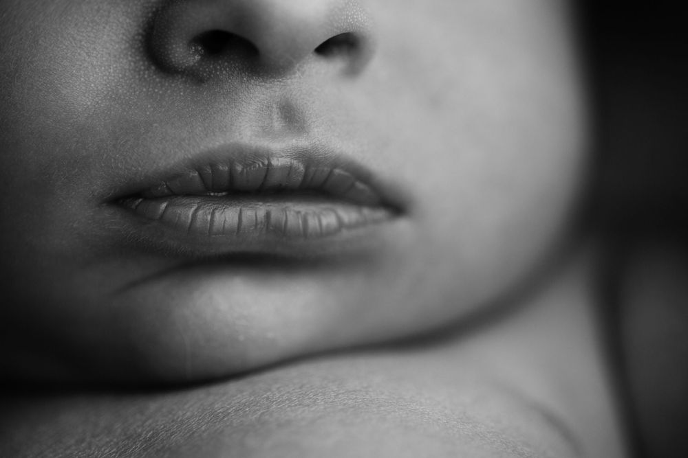 Black and white macro image of baby's lips.