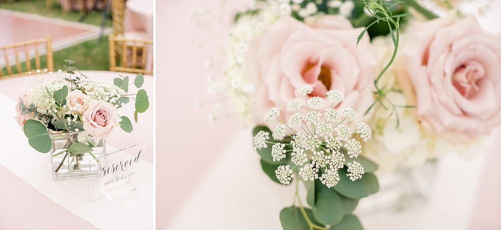 Delicate pink and white floral wedding centerpiece with roses and baby's breath.