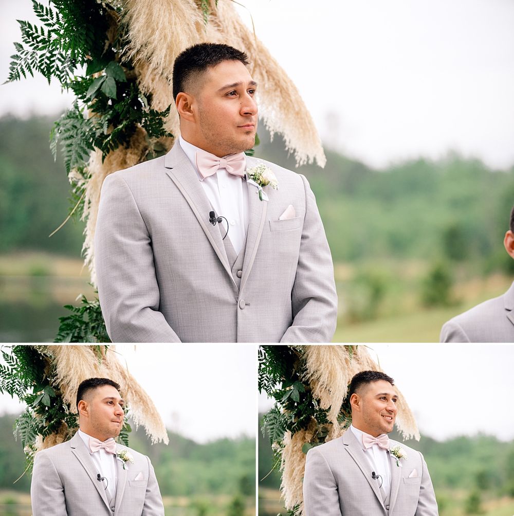 A wedding ceremony moment captured under a floral arch with pampas grass accents.