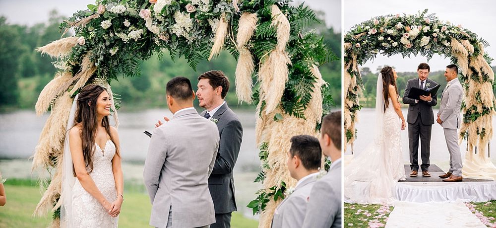 Wedding ceremony under a lush floral arch with pampas grass by the lake.