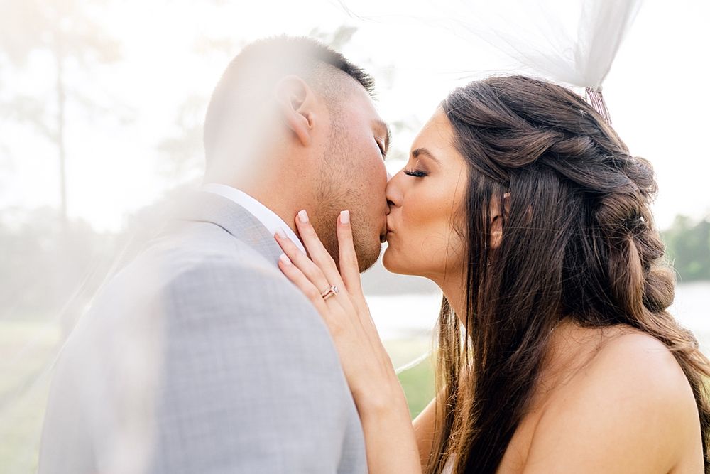 Romantic sunset wedding portrait capturing a tender moment between newlyweds.