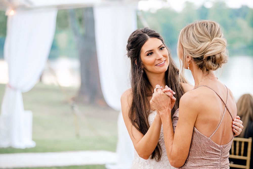 Candid moments shared between wedding attendees during an outdoor celebration.