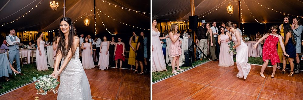 Joyful wedding guests dancing at a reception under twinkling lights in a tent venue.