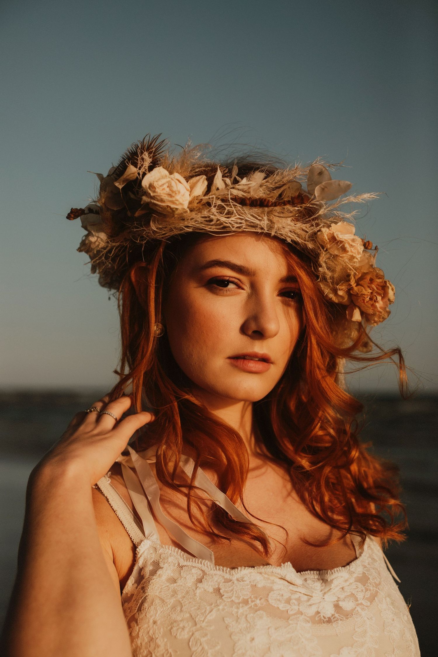 Dakota Blue Richards wearing a floral crown at sunset on the beach