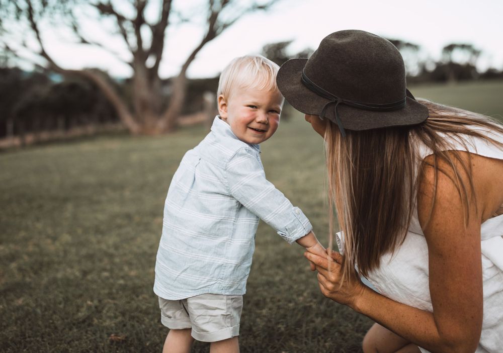 Joyful laughter and connection captured in an outdoor setting with natural lighting.
