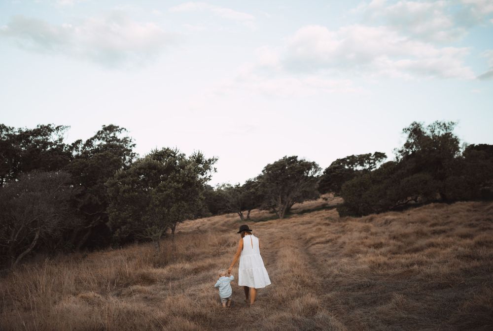 Silhouettes walking together on a hillside during golden hour.