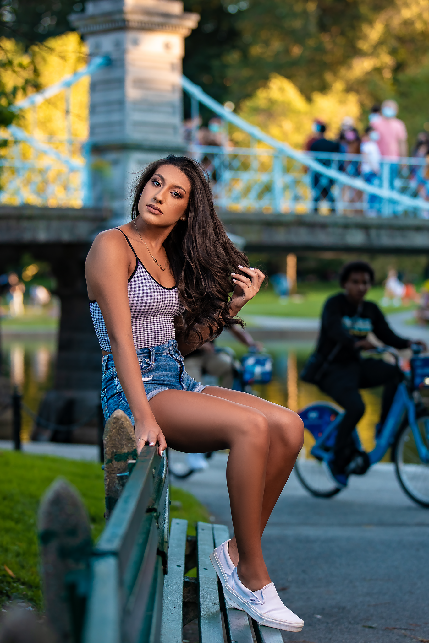Summer portrait session on park bench with warm golden hour lighting.
