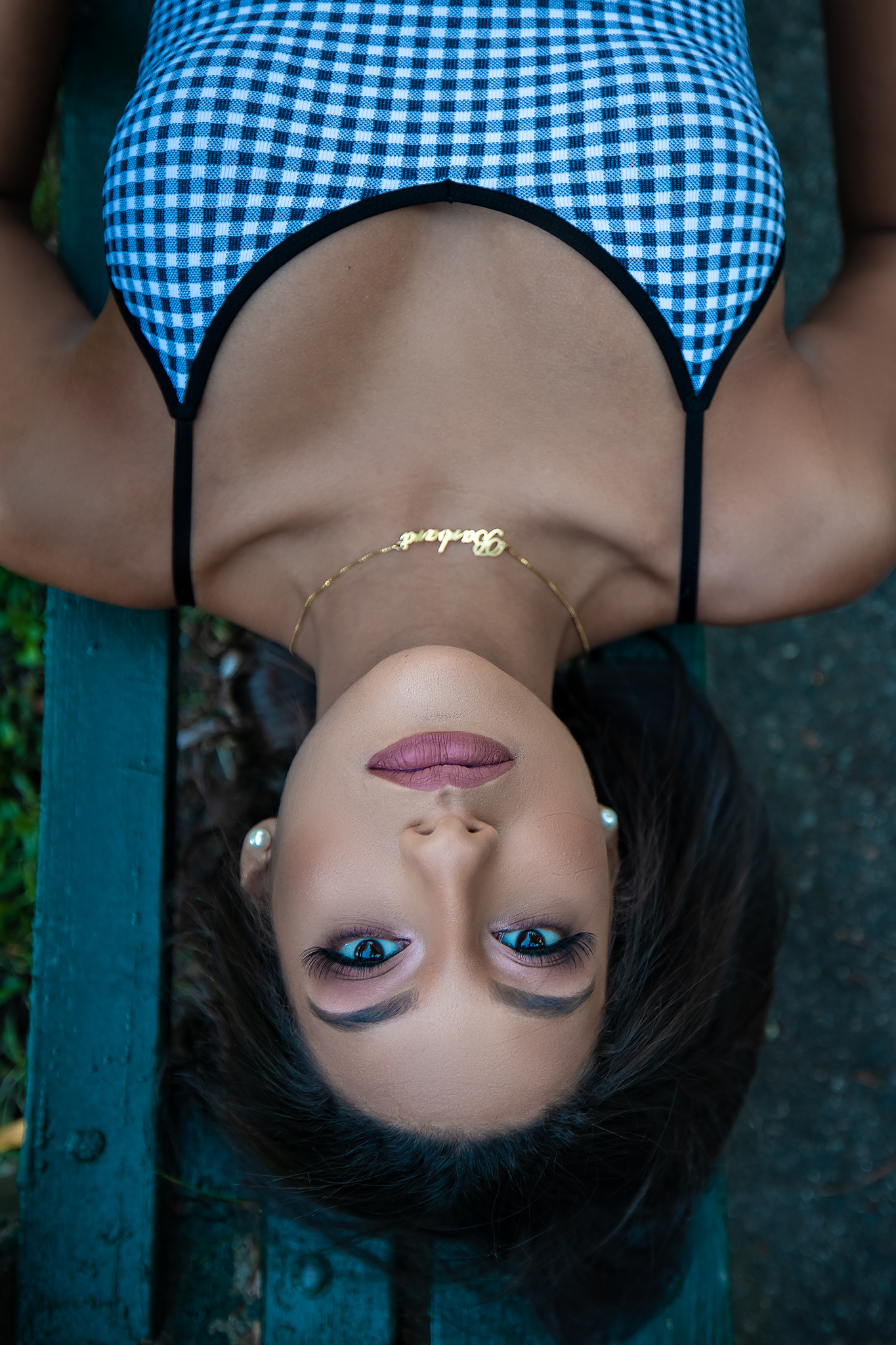 Blue gingham pattern outfit captured in creative upside down perspective.