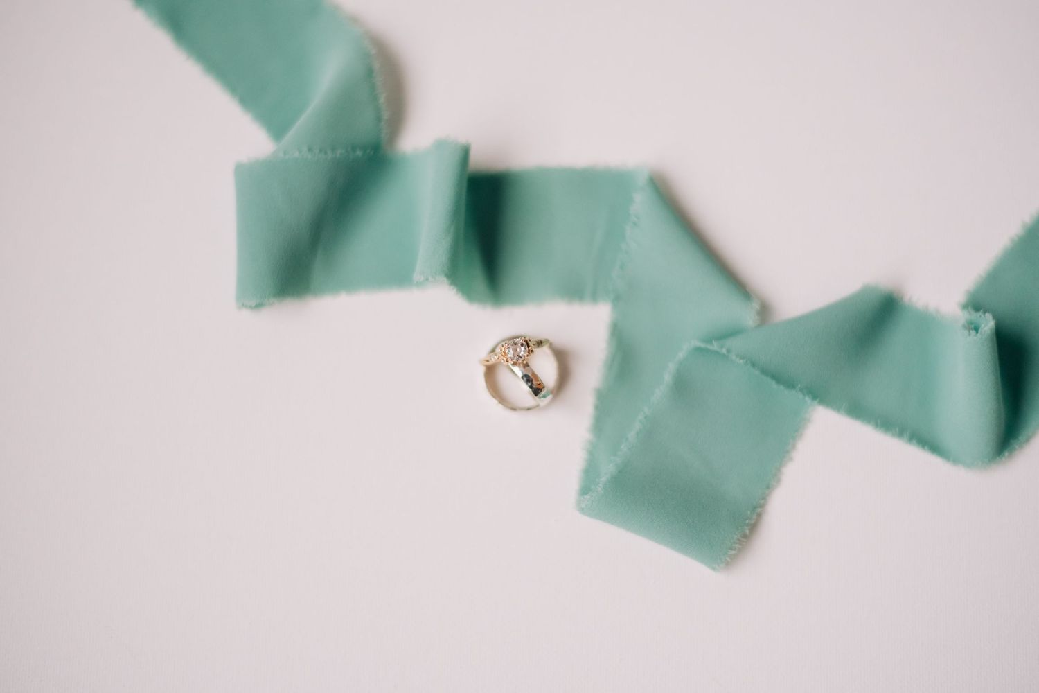 wedding rings and green ribbon