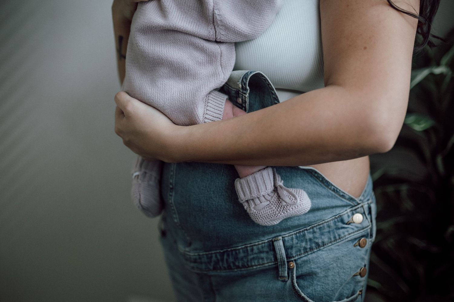 postpartum mother holding newborn baby girl in her arms suffolk, virginia