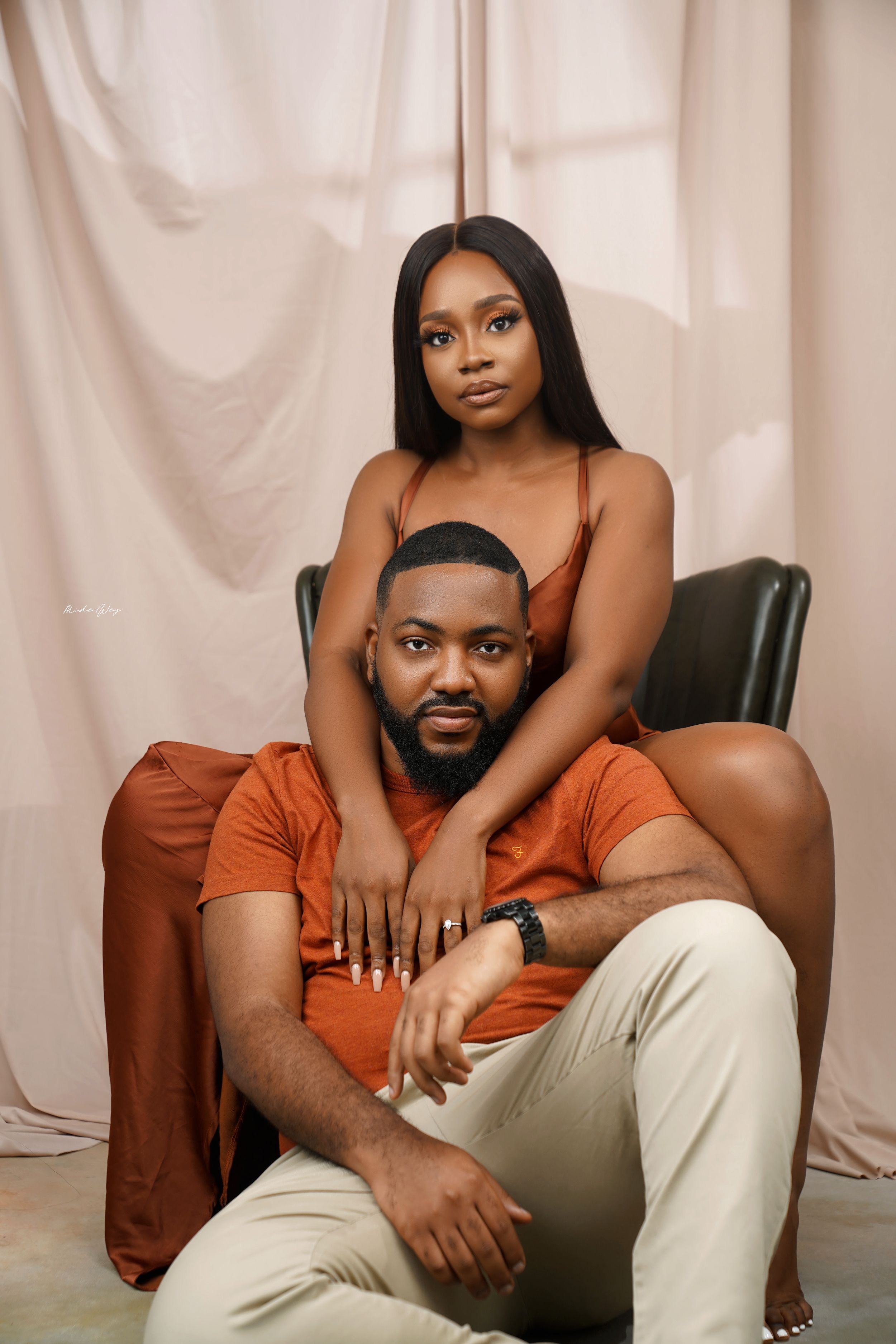 Intimate couple photoshoot against white backdrop showing romantic poses and tender moments.