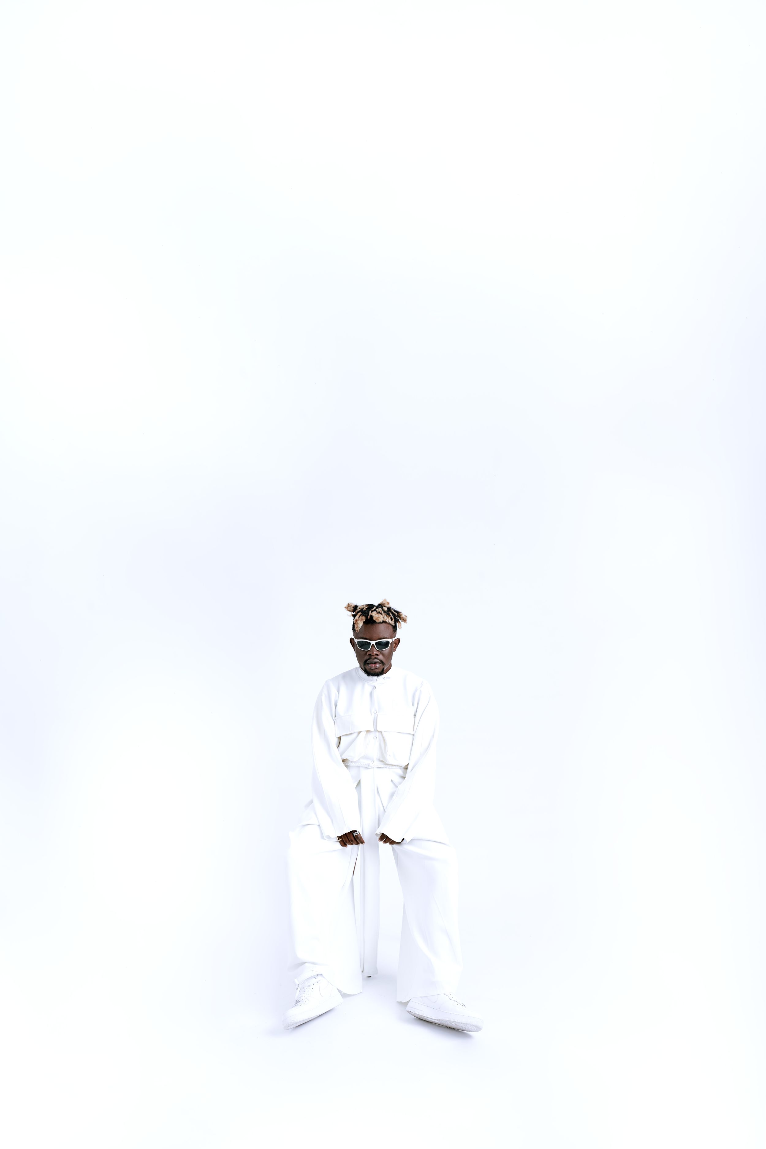Artistic portrait series against white background wearing all-white outfit.