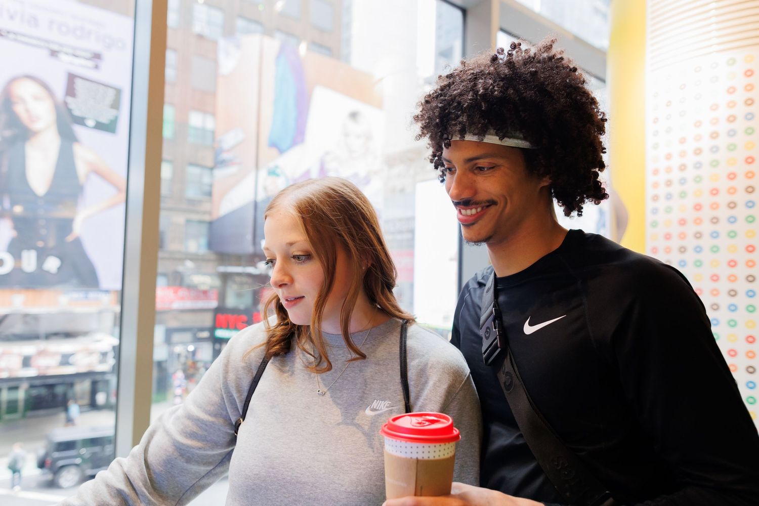 Casual coffee shop engagement session with relaxed conversation and laughter.