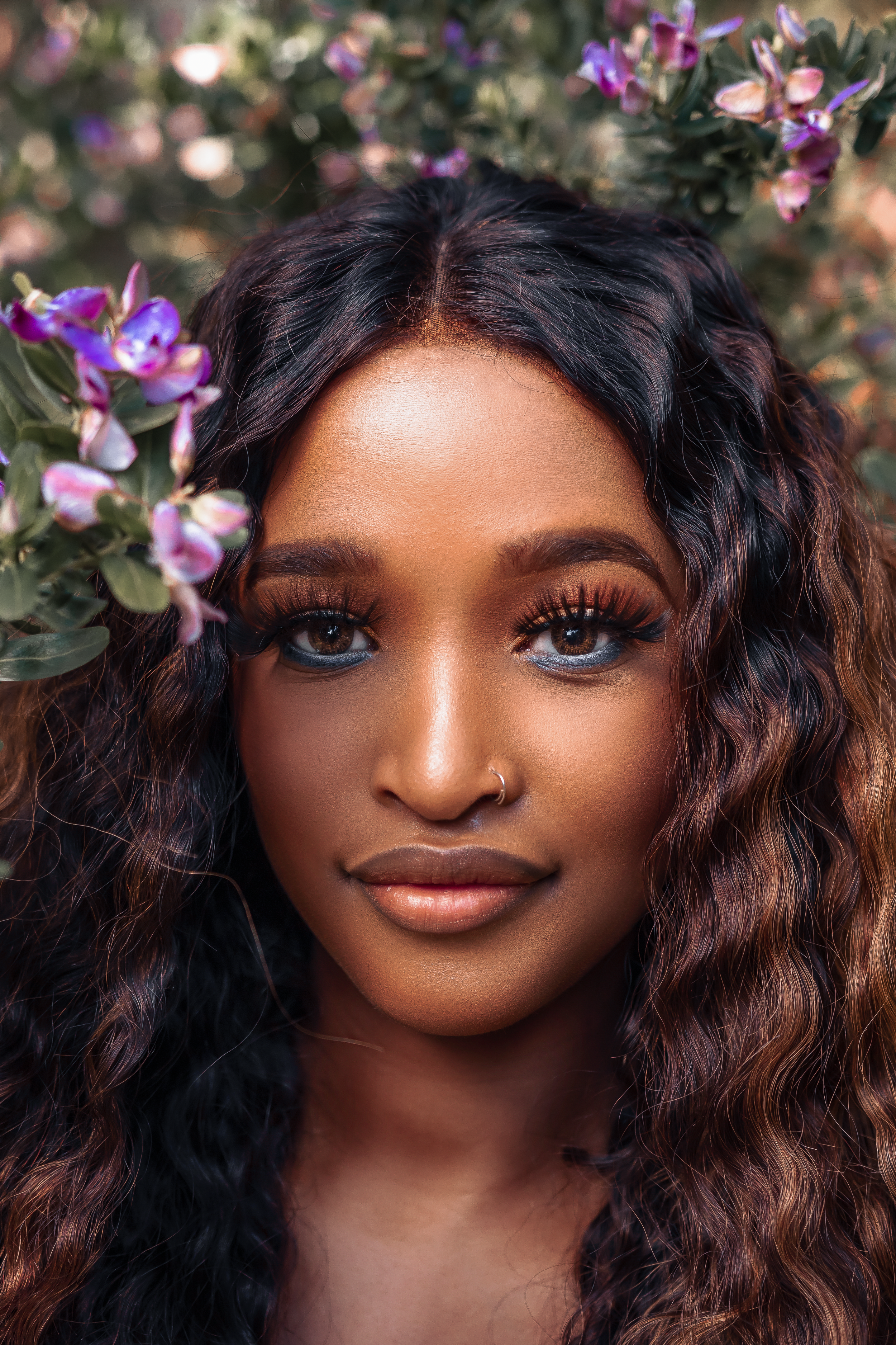Beautiful portrait amongst purple flowering bushes with soft natural lighting.