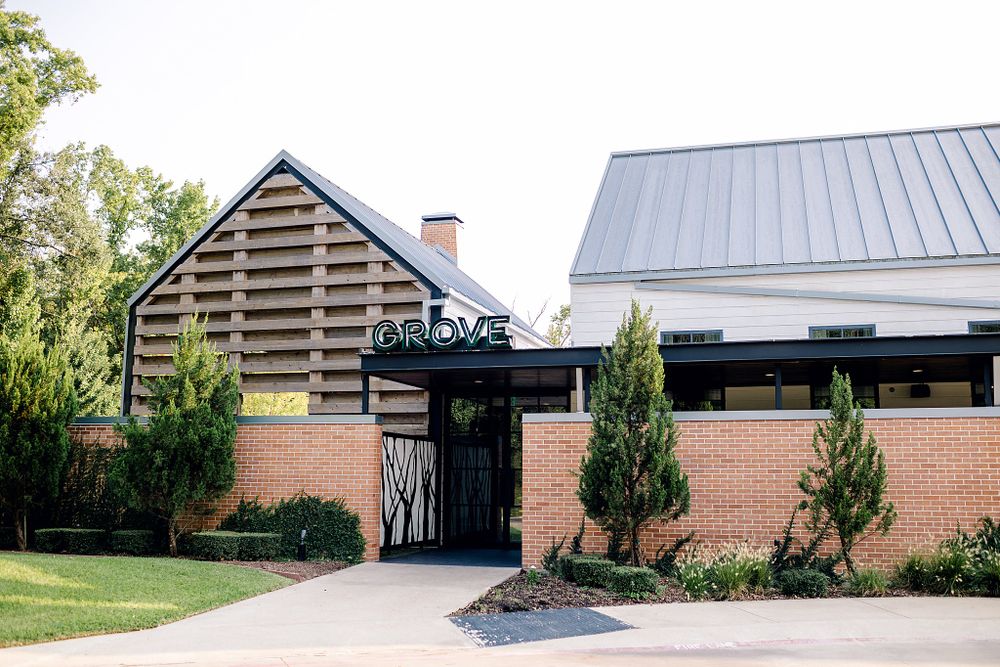 Modern brick wedding venue exterior with metal roof and contemporary architectural details.