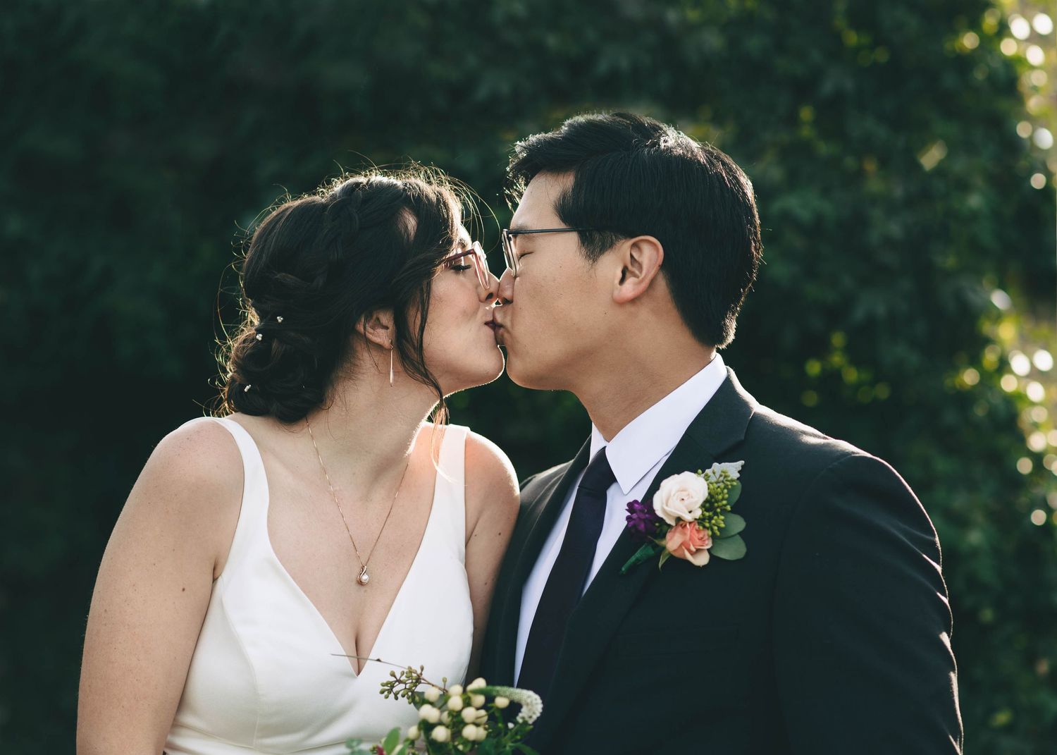 Bride and groom sharing a kiss, in the garden at the barns at cooper molera in Monterey
