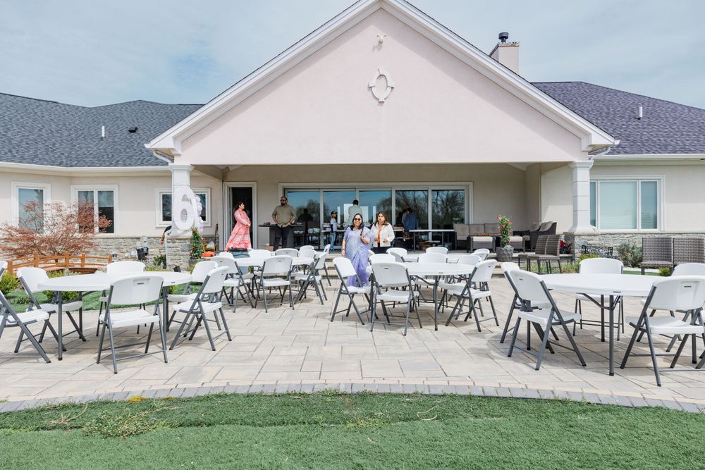 Outdoor event space with folding chairs set up on patio.