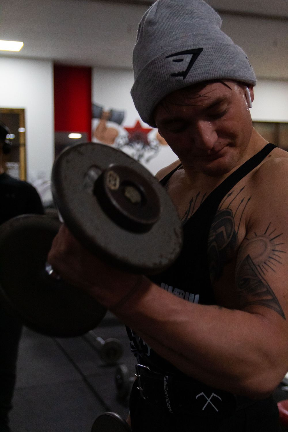 man doing bicep curls in metroflex gym in oceanside, ca