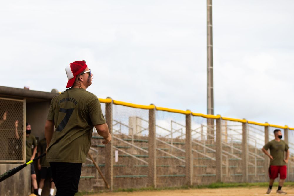 man hitting home run in softball game in camp hansen, okinawa, japan