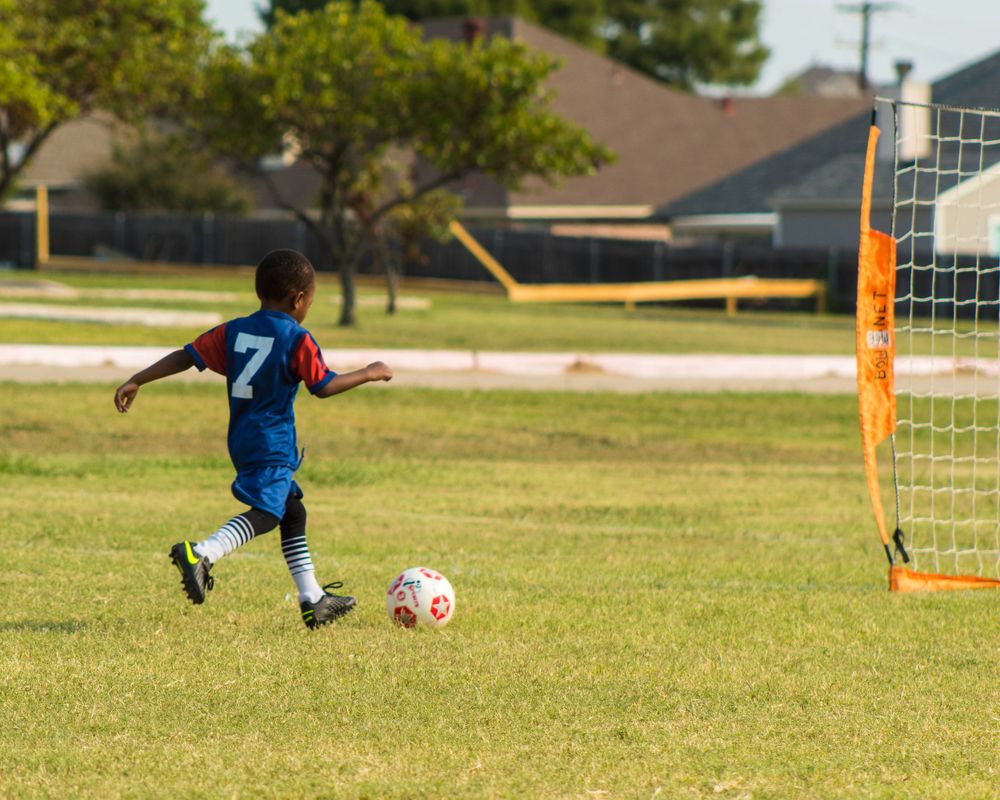 kid dribbling a soccer ball
