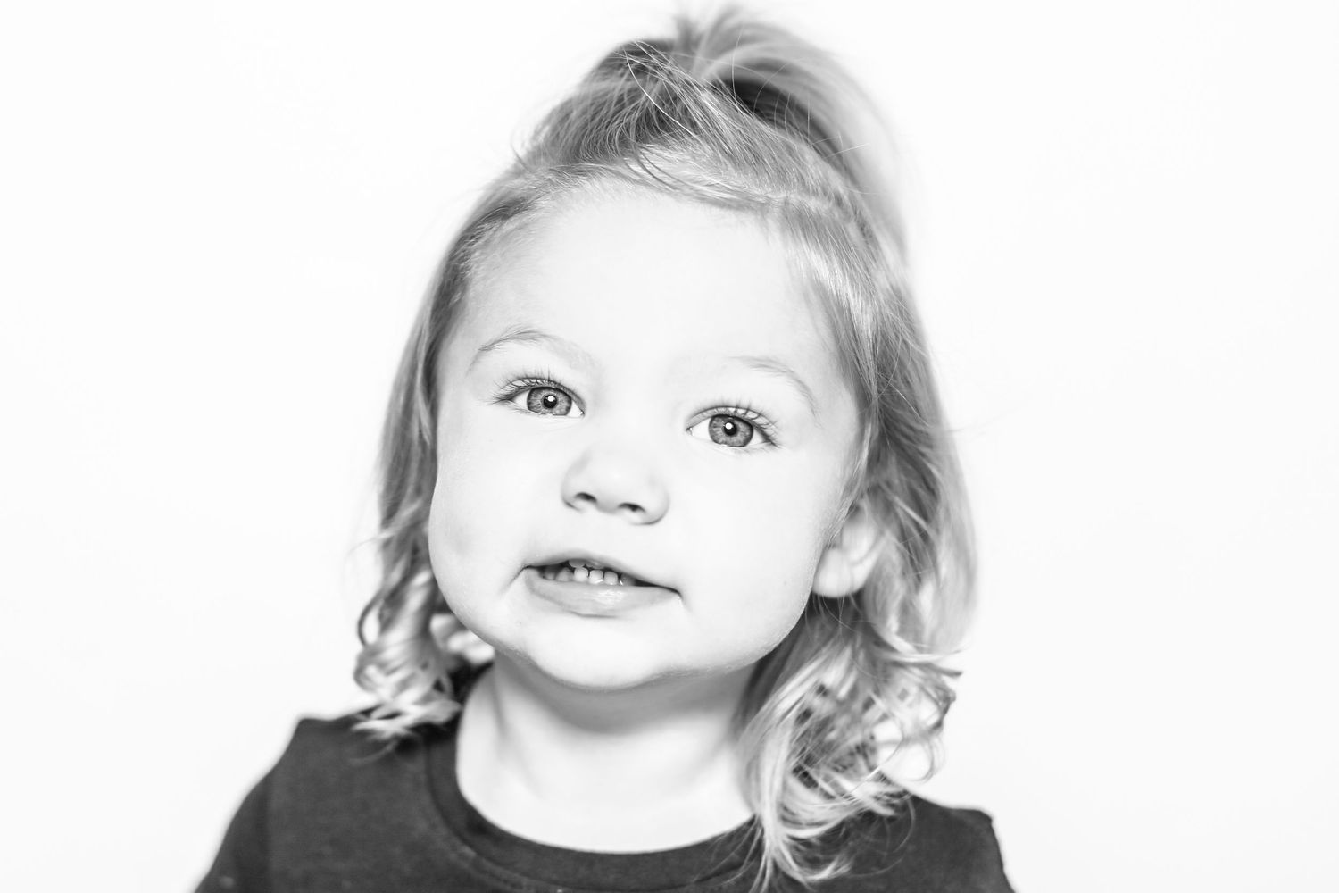 little girl smiles at camera in portrait by Stephanie Le Shana photography