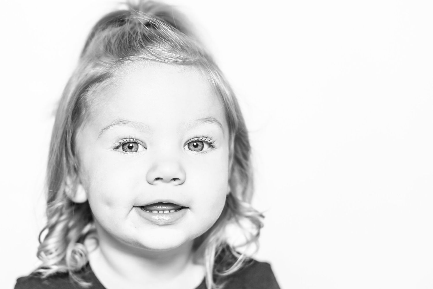 little girl smiles at camera in portrait by Stephanie Le Shana photography
