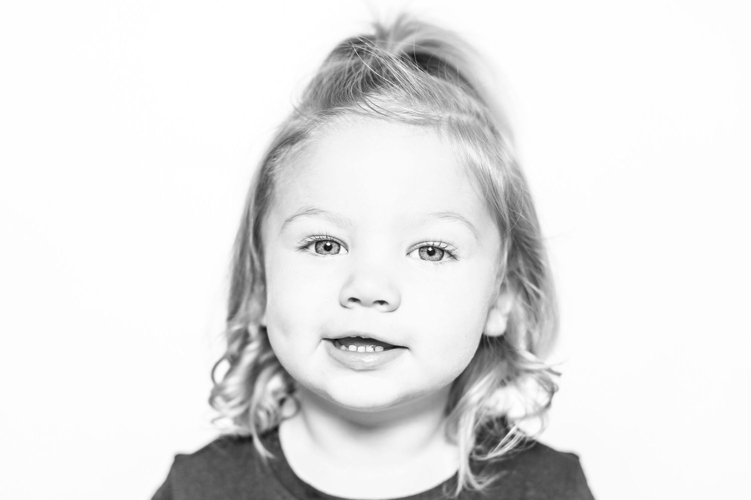 little girl smiles at camera in portrait by Stephanie Le Shana photography