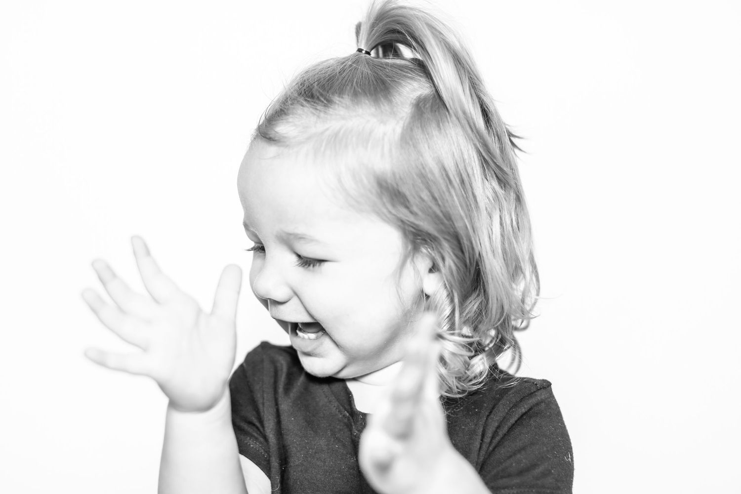 little girls claps and looks excited in portrait by Stephanie Le Shana photography