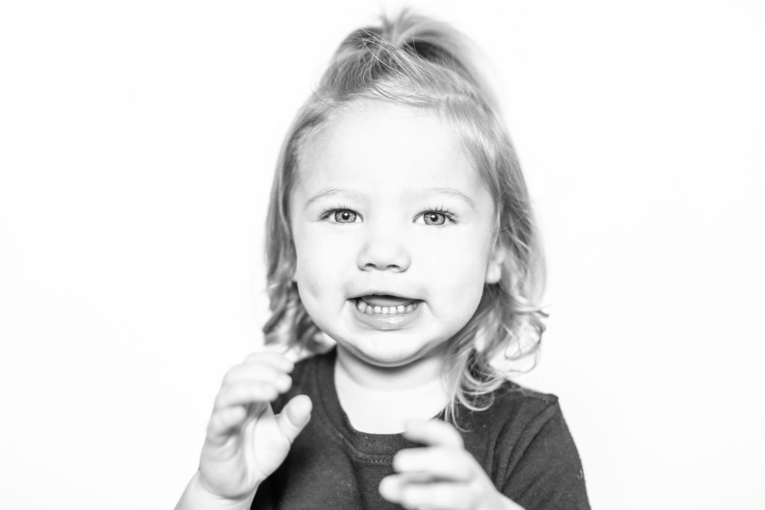 little girls smiles at camera in portrait by Stephanie Le Shana photography