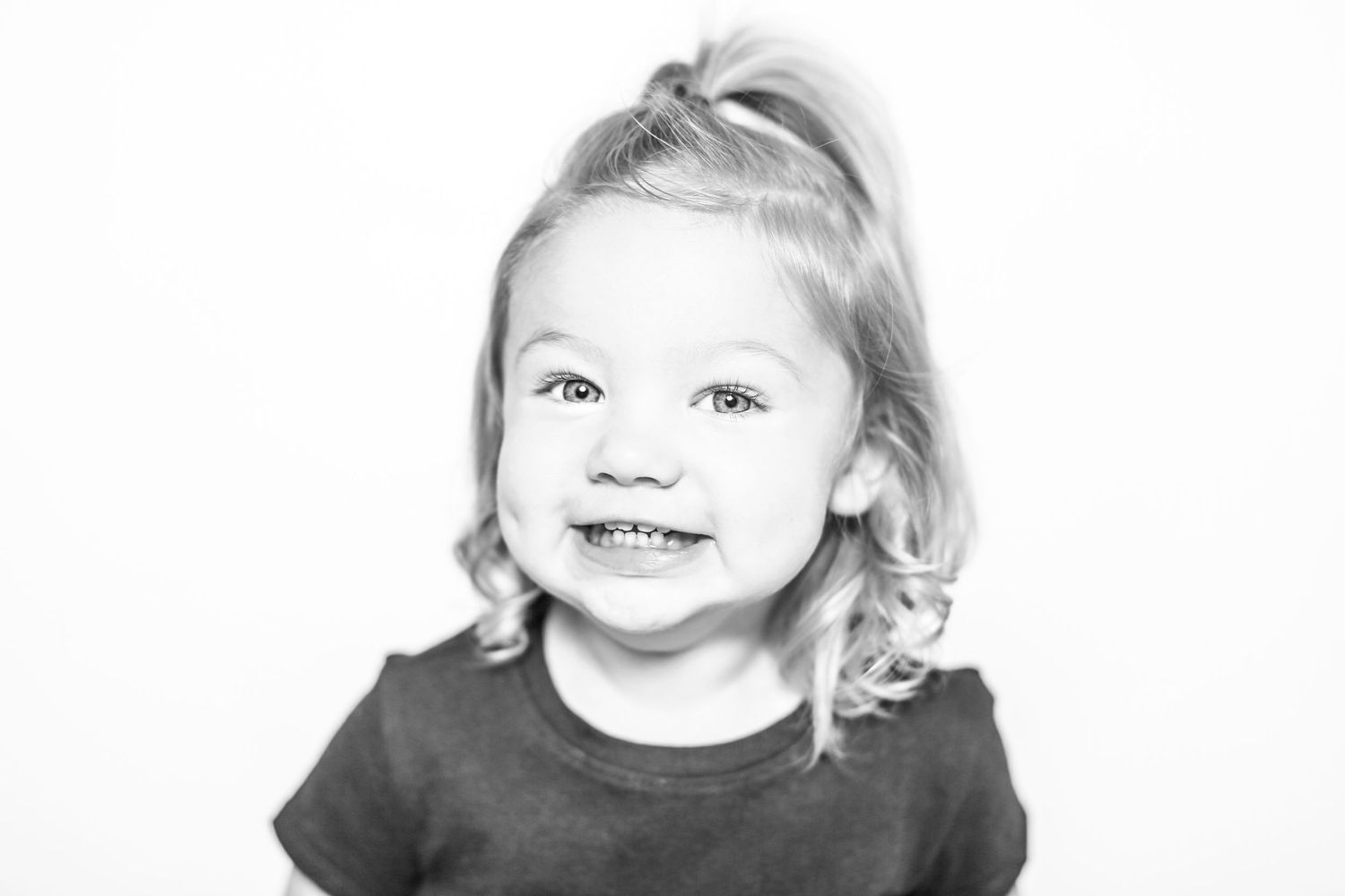 little girl smiles at camera in portrait by Stephanie Le Shana photography