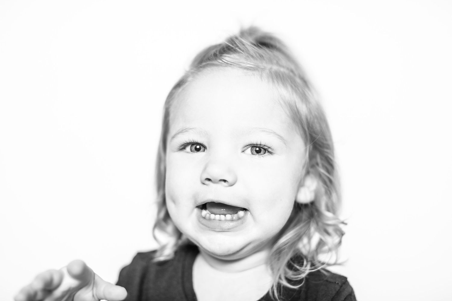 little girl smiles at camera in portrait by Stephanie Le Shana photography