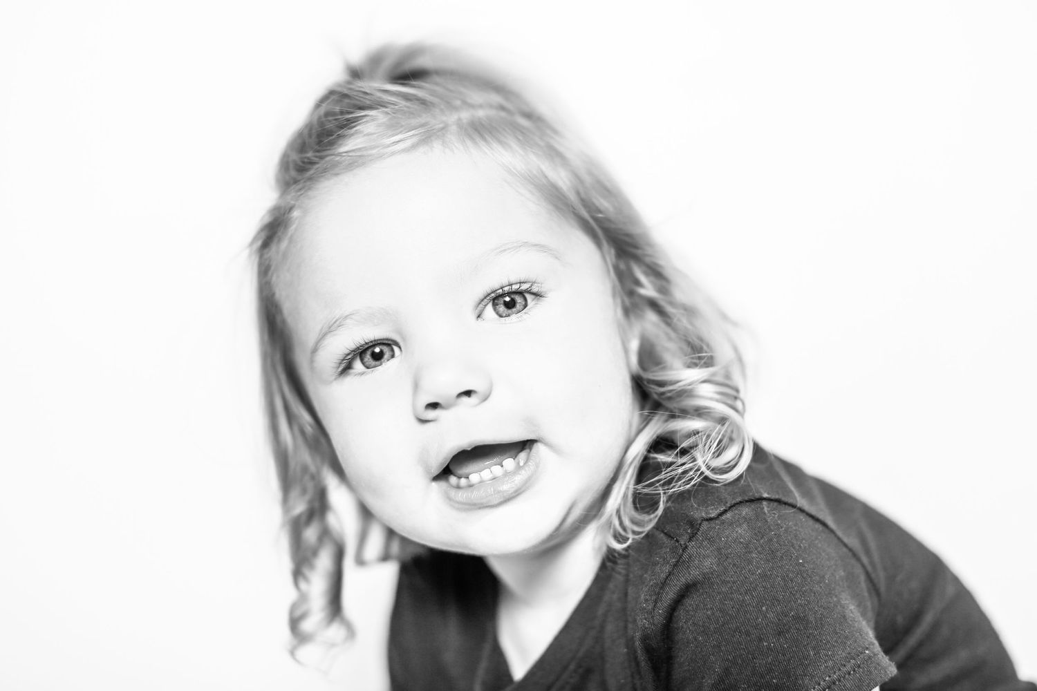 little girl smiles at camera in portrait by Stephanie Le Shana photography