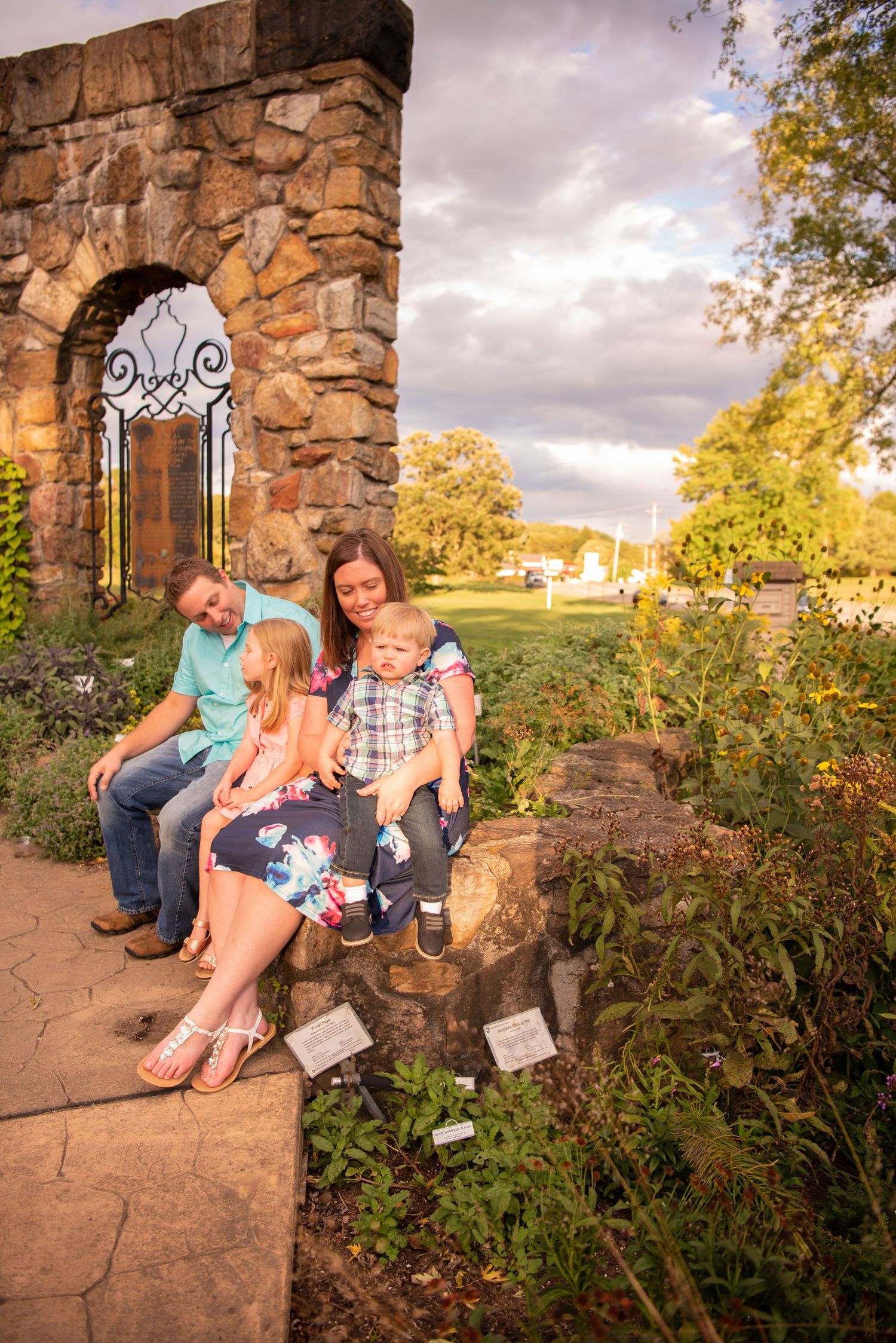family of four sitting close at north park at sunset