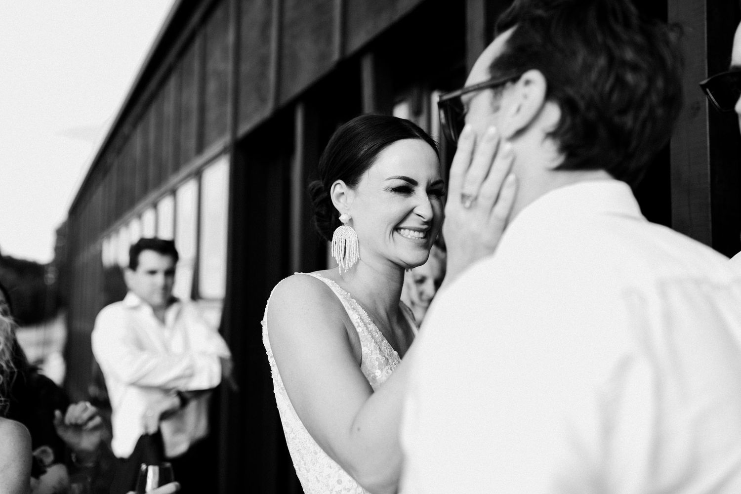 Candid black and white photo of joyful moments during wedding celebration.