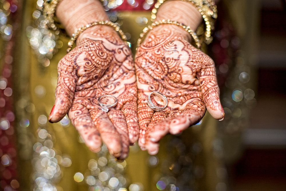 a bride's hands with henna on them, in the style of pointillist dots and specks, intricate costumes, intricate embellish