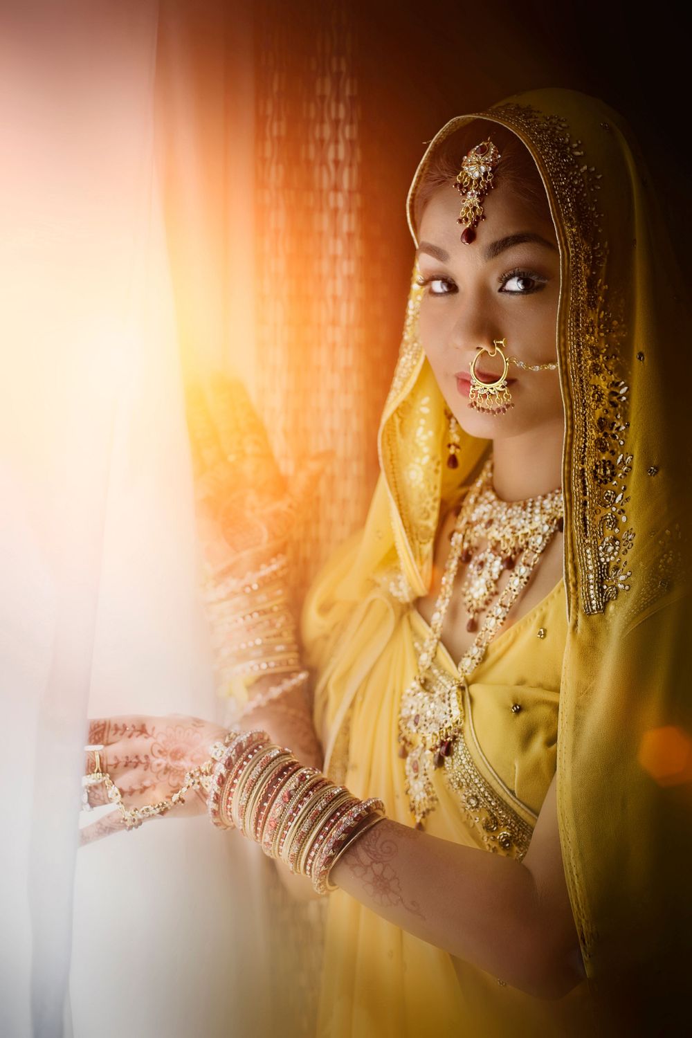 a indian bride holding her hand over a window, in the style of light amber and yellow, 32k uhd, caras ionut