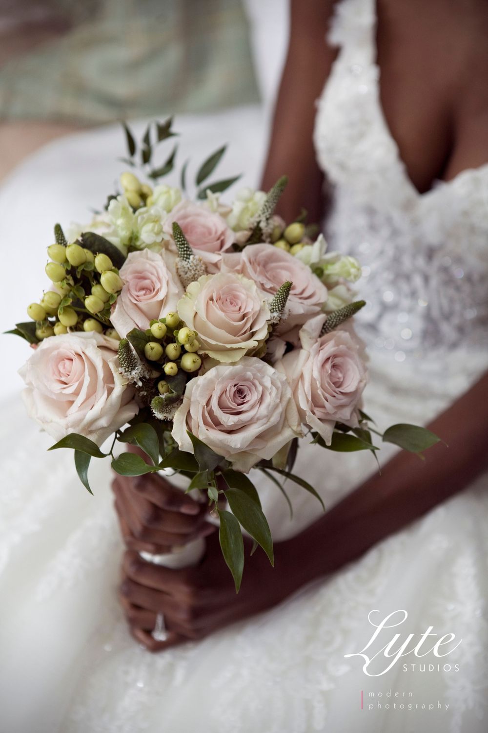 a beautiful bride is holding a bouquet of flowers, in the style of subtle pastel hues