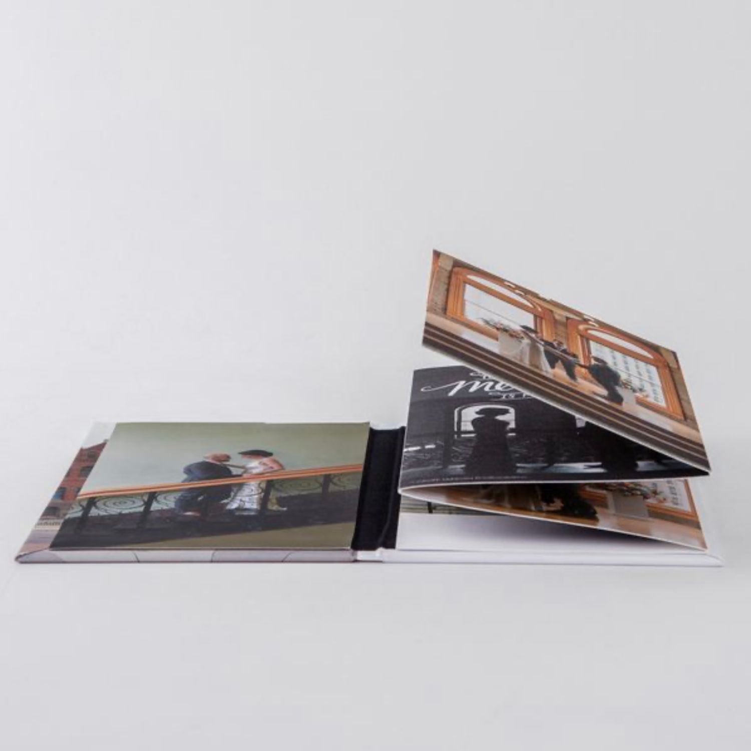 Side view of photo prints arranged in an accordion-style display on light gray surface.