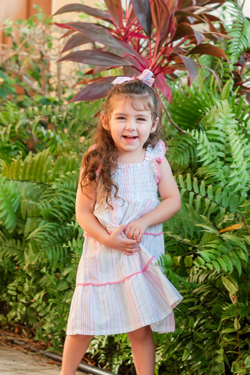 four year old little girl laughs in old town square in Winter Haven, Florida