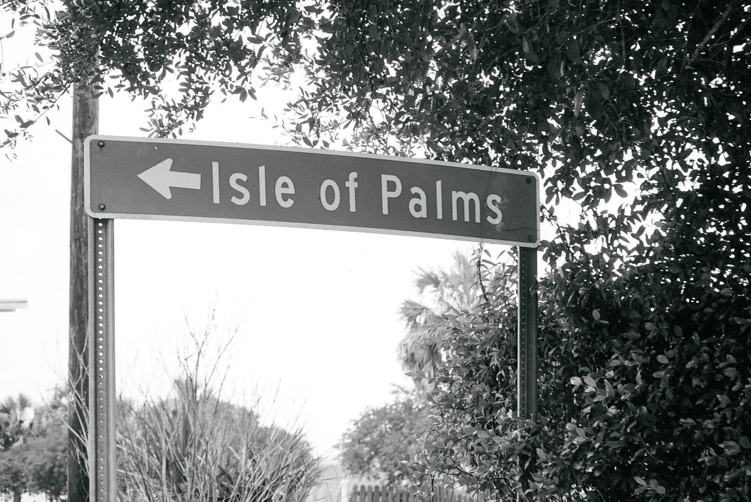 Vintage black and white street sign pointing to Isle of Palms.