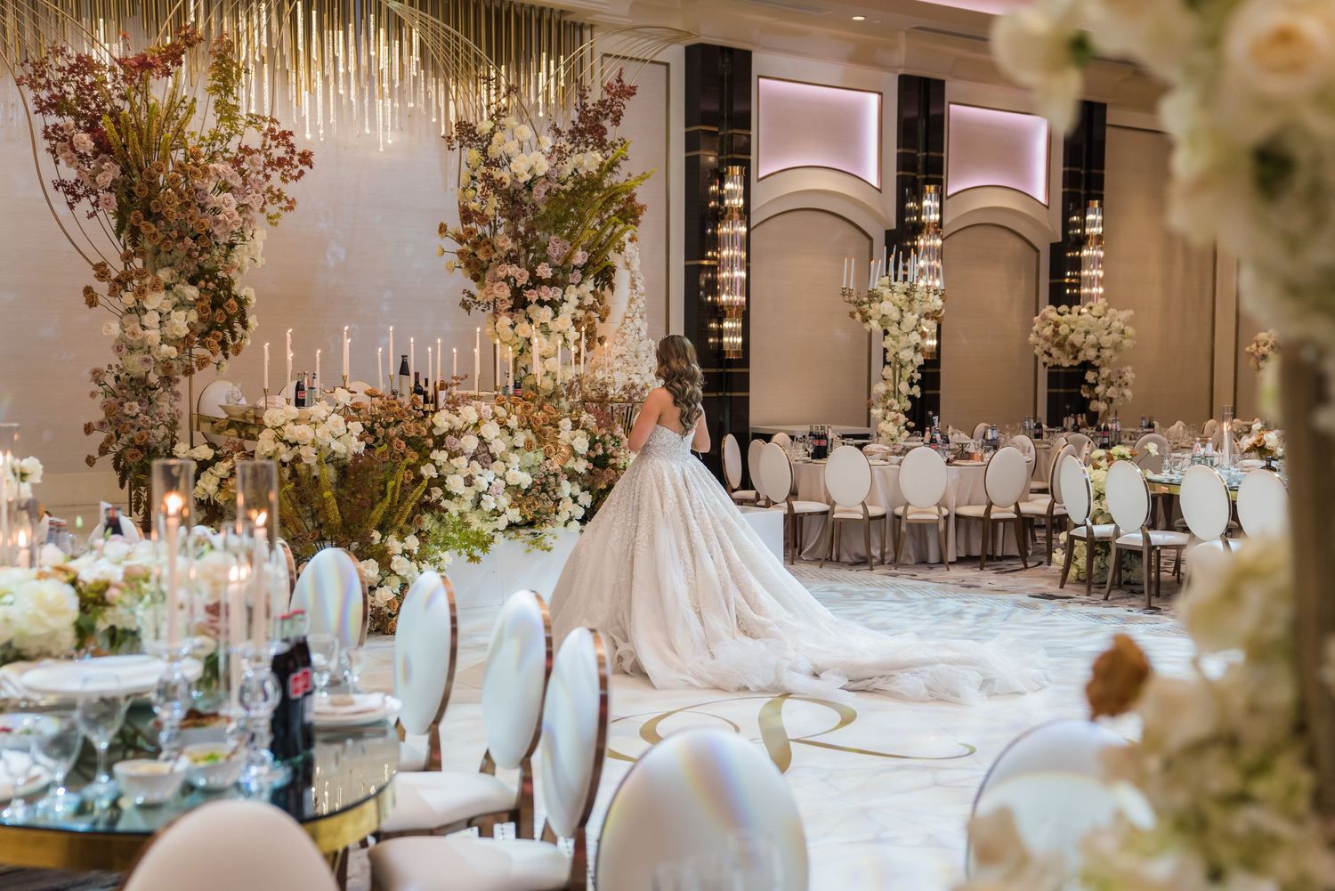 Elegant wedding reception venue decorated with floral arrangements and crystal chandeliers.
